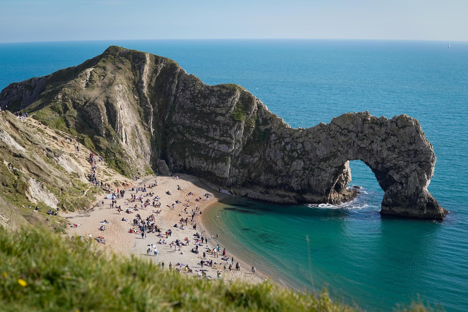 Aerial view of the Dorset coastline with golden cliffs and blue sea